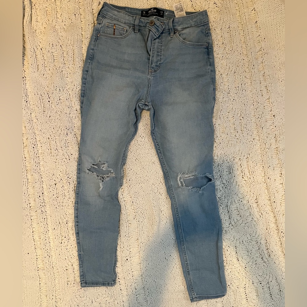 Size 7, medium wash blue skinny jeans with rips from Hollister.